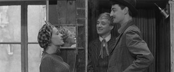 Movie still from “Jules and Jim” (1962), directed by François Truffaut – A man and a woman standing next to each other in front of a mirror; Medium shot, Over the shoulder angle