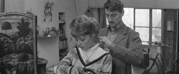 Movie still from “Jules and Jim” (1962), directed by François Truffaut – A man and a woman are getting their hair cut; Medium shot, Over the shoulder angle