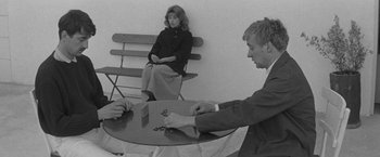 Movie still from “Jules and Jim” (1962), directed by François Truffaut – A man and a woman sitting at a table; Medium shot, Over the shoulder angle