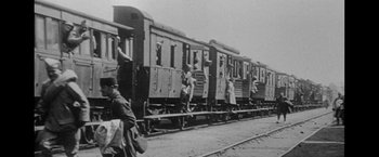 Movie still from “Jules and Jim” (1962), directed by François Truffaut – A black - and - white photo of people on a train; Extreme Wide shot, Low angle