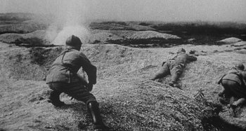 Movie still from “Jules and Jim” (1962), directed by François Truffaut – Two men in military uniforms on a rocky hill; Wide shot, High angle