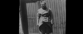 Movie still from “Jules and Jim” (1962), directed by François Truffaut – An old photo of a man in a military uniform; Medium shot, High angle