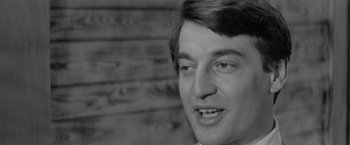 Movie still from “Jules and Jim” (1962), directed by François Truffaut – A man's face in black - and - white; Close Up shot, Low angle