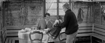 Movie still from “Jules and Jim” (1962), directed by François Truffaut – Two men and a little girl at a dinner table; Medium shot, Over the shoulder angle