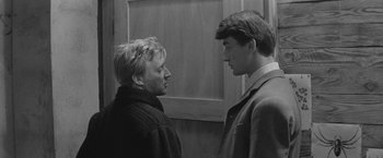 Movie still from “Jules and Jim” (1962), directed by François Truffaut – Two people standing next to each other face to face; Medium shot, Low angle