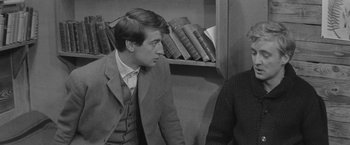 Movie still from “Jules and Jim” (1962), directed by François Truffaut – A black and white photo of a man in a suit and tie; Medium shot, Over the shoulder angle