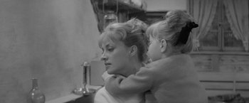 Movie still from “Jules and Jim” (1962), directed by François Truffaut – A black and white photo of a woman and a child; Close Up shot, Over the shoulder angle