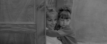 Movie still from “Jules and Jim” (1962), directed by François Truffaut – A woman and a child are hugging in a doorway; Close Up shot, High angle