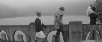Movie still from “Jules and Jim” (1962), directed by François Truffaut – A man and a woman walking along a pier; Wide shot, High angle