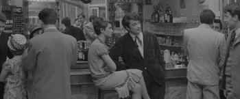 Movie still from “Jules and Jim” (1962), directed by François Truffaut – A man and a woman sitting at a bar together; Medium shot, Over the shoulder angle