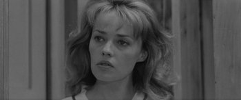 Movie still from “Jules and Jim” (1962), directed by François Truffaut – Black and white photograph of a woman looking at the camera; Close Up shot, Over the shoulder angle