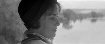 Movie still from “Jules and Jim” (1962), directed by François Truffaut – A black - and - white photo of a woman looking out a window; Close Up shot, Over the shoulder angle