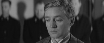 Movie still from “Jules and Jim” (1962), directed by François Truffaut – Black and white photograph of a man in a suit; Close Up shot, Over the shoulder angle