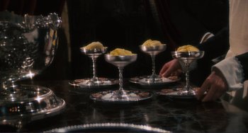 Movie still from “Julia” (1977), directed by Fred Zinnemann – A group of small silver dishes filled with food on top of a table; Close Up shot, High angle