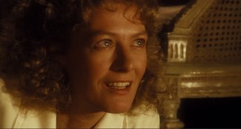 Movie still from “Julia” (1977), directed by Fred Zinnemann – A woman's face with a building in the background; Close Up shot, Low angle