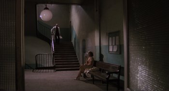 Movie still from “Julia” (1977), directed by Fred Zinnemann – A woman sitting on top of a wooden park bench; Wide shot, High angle