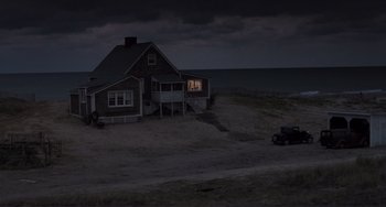 Movie still from “Julia” (1977), directed by Fred Zinnemann – A car parked in front of a house on the beach at night; Extreme Wide shot, High angle