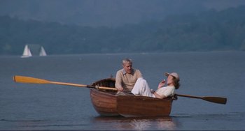 Movie still from “Julia” (1977), directed by Fred Zinnemann – A man and a woman in a boat on a lake; Wide shot, High angle