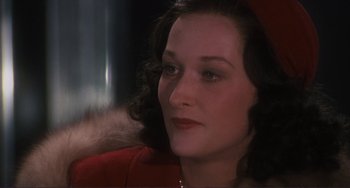 Movie still from “Julia” (1977), directed by Fred Zinnemann – A person sitting in a chair; Close Up shot, Over the shoulder angle