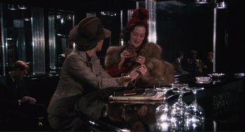 Movie still from “Julia” (1977), directed by Fred Zinnemann – Two women sitting at a table in a room; Medium shot, Over the shoulder angle