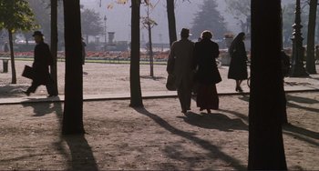Movie still from “Julia” (1977), directed by Fred Zinnemann – A man and a woman walking down a sidewalk; Wide shot, High angle