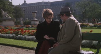 Movie still from “Julia” (1977), directed by Fred Zinnemann – A man and a woman sitting on a park bench; Medium shot, Over the shoulder angle