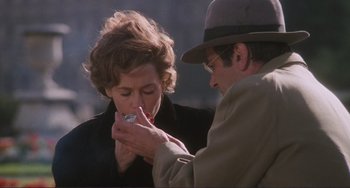 Movie still from “Julia” (1977), directed by Fred Zinnemann – An older man and a younger woman are eating something together; Close Up shot, Over the shoulder angle