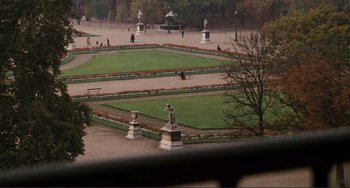 Movie still from “Julia” (1977), directed by Fred Zinnemann – A view of a garden with a statue in the center; Extreme Wide shot, High angle