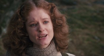 Movie still from “Julia” (1977), directed by Fred Zinnemann – A young woman with long red curly hair wearing a scarf; Close Up shot, Low angle