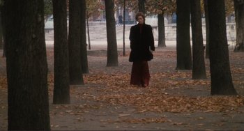 Movie still from “Julia” (1977), directed by Fred Zinnemann – A woman is walking through the leaves in a park; Wide shot, High angle