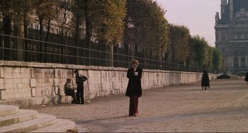 Movie still from “Julia” (1977), directed by Fred Zinnemann – An older woman standing on the side of a road; Wide shot, High angle