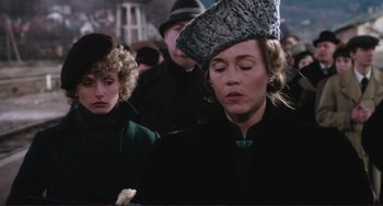 Movie still from “Julia” (1977), directed by Fred Zinnemann – A woman wearing a hat is standing next to another woman; Close Up shot, Over the shoulder angle