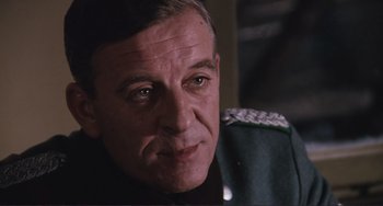 Movie still from “Julia” (1977), directed by Fred Zinnemann – A person wearing a military uniform; Close Up shot, Low angle