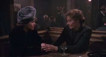Movie still from “Julia” (1977), directed by Fred Zinnemann – Two women sitting at a table in front of a glass of wine; Medium shot, Over the shoulder angle