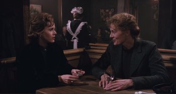 Movie still from “Julia” (1977), directed by Fred Zinnemann – Two people sitting at a table in front of a waiter; Medium shot, Over the shoulder angle