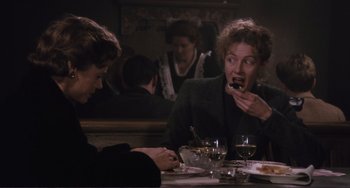 Movie still from “Julia” (1977), directed by Fred Zinnemann – Two women are sitting at a dinner table and one of them is eating; Medium shot, Over the shoulder angle