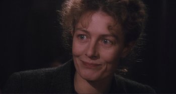 Movie still from “Julia” (1977), directed by Fred Zinnemann – A person smiling for the camera; Close Up shot, Over the shoulder angle