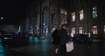 Movie still from “Julia” (1977), directed by Fred Zinnemann – A man and a woman walking down a street at night; Wide shot, High angle