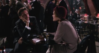 Movie still from “Julia” (1977), directed by Fred Zinnemann – A man and a woman sitting at a table in front of each other; Medium shot, High angle