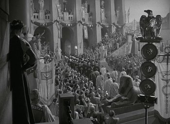 Movie still from “Julius Caesar” (1953), directed by Joseph L. Mankiewicz – A crowd of people gathered in front of a building; Extreme Wide shot, High angle