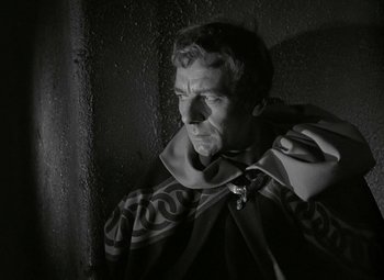Movie still from “Julius Caesar” (1953), directed by Joseph L. Mankiewicz – A black and white photo of a man wearing a cape; Close Up shot, Over the shoulder angle