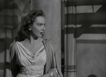 Movie still from “Julius Caesar” (1953), directed by Joseph L. Mankiewicz – A black - and - white photo of a woman looking to her left; Medium shot, Over the shoulder angle