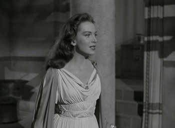 Movie still from “Julius Caesar” (1953), directed by Joseph L. Mankiewicz – A black and white photo of a woman in a dress; Medium shot, Over the shoulder angle