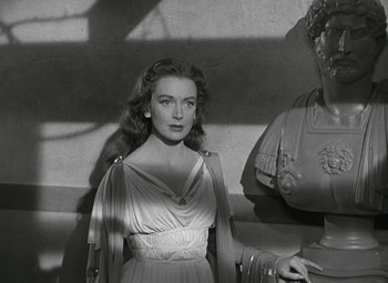 Movie still from “Julius Caesar” (1953), directed by Joseph L. Mankiewicz – A black and white photo of a woman in a dress; Medium shot, Low angle