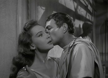 Movie still from “Julius Caesar” (1953), directed by Joseph L. Mankiewicz – A man and a woman kissing in a black and white photo; Close Up shot, Over the shoulder angle
