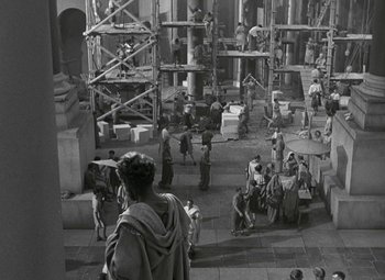 Movie still from “Julius Caesar” (1953), directed by Joseph L. Mankiewicz – A group of people standing around in a large building; Extreme Wide shot, High angle