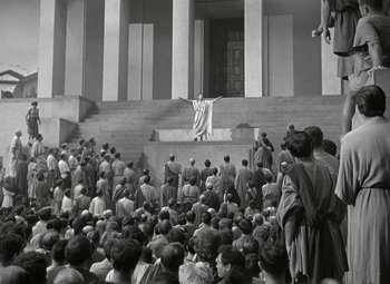 Movie still from “Julius Caesar” (1953), directed by Joseph L. Mankiewicz – A crowd of people gathered in front of a building; Extreme Wide shot, Low angle