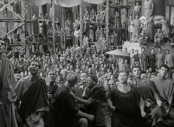 Movie still from “Julius Caesar” (1953), directed by Joseph L. Mankiewicz – A large group of people gathered together in a building; Wide shot, High angle