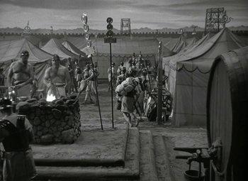 Movie still from “Julius Caesar” (1953), directed by Joseph L. Mankiewicz – A group of people standing in a field with tents; Extreme Wide shot, High angle