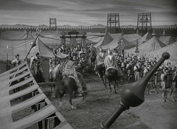 Movie still from “Julius Caesar” (1953), directed by Joseph L. Mankiewicz – A black and white photo of a crowd of people riding horses; Extreme Wide shot, High angle